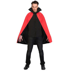 Person wearing a black shirt and red cape on a white background