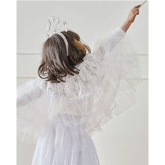 Girl in a white and Silver Fairy cape with silver star embellishments against a plain background