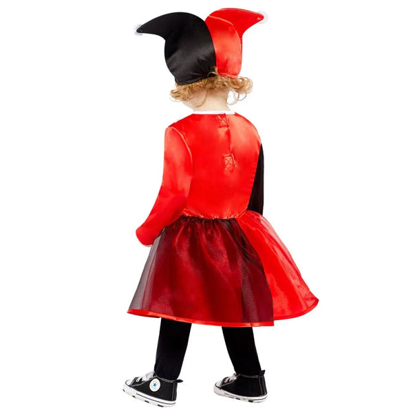 Child wearing a red and black jester costume on a white background