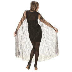 Woman wearing a black dress with a spiderweb cape on a white background