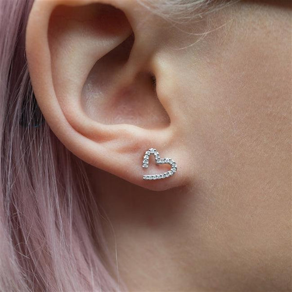 Modern White Gold Diamond Heart Earrings Being Worn By A Model