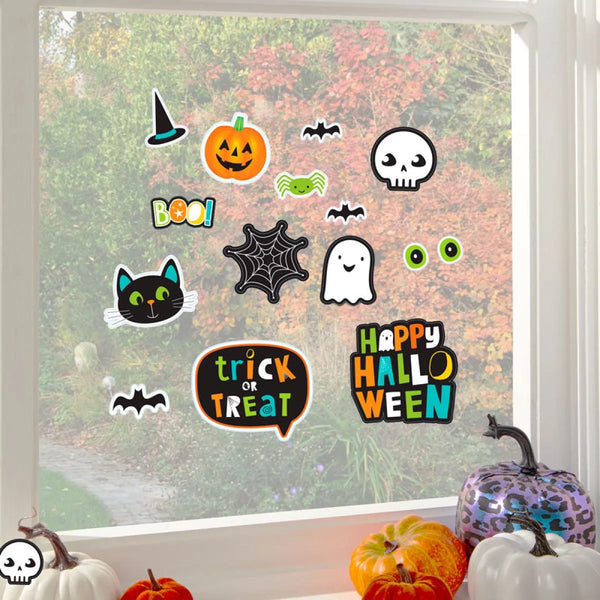Halloween-themed window stickers on a glass pane with pumpkins and decorations.