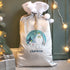Silver Christmas sack with a snowman design and 'Charlotte' text, surrounded by festive decorations.