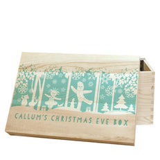 A Pine In The Night Garden Snowtime Christmas Eve Box Featuring A Name Of Your Choice Followed By "CHRISTMAS EVE BOX" Aqua Text Written Under A Snowy Scene