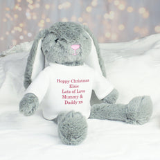 Grey fluffy bunny sitting down with text that reads "Happy Christmas Elsie Lots of Love Mummy & Daddy xx" on the bunny's top