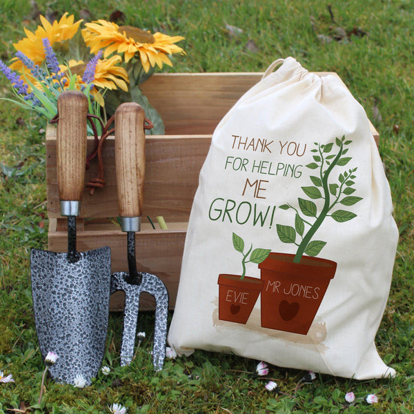 Helping Me To Grow Garden Tool Set - Resting Against A Garden Box
