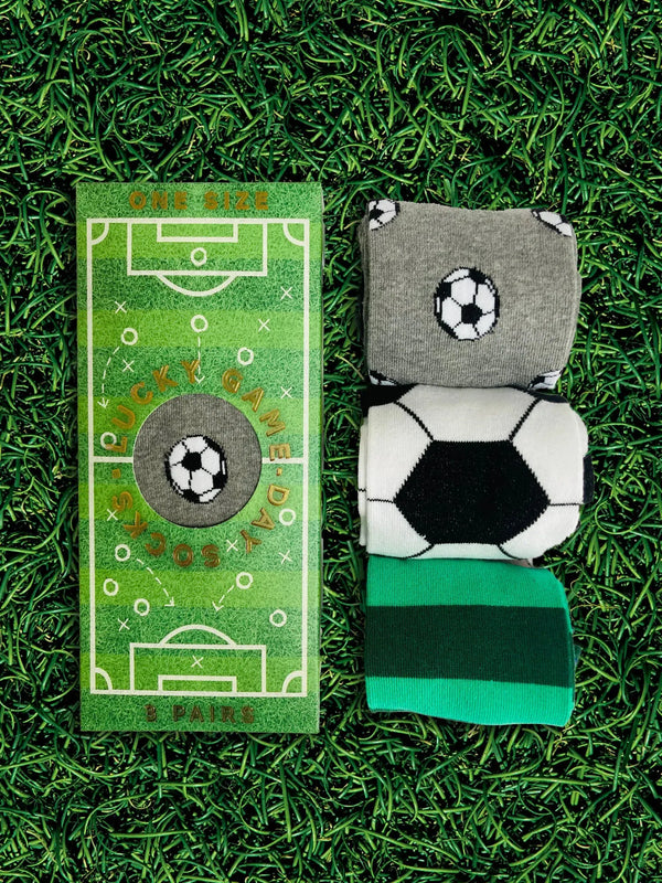 Rolled up football socks next to a football pitch box