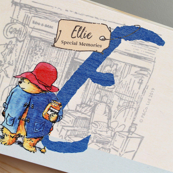 Paddington Bear Initial Memory Box - Lid Featuring Paddington Holding His Honey Standing By The Initial E With A Tag Hanging Off The Initial Featuring Ellie Above Special Memories Wording