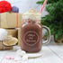 Personalised Mason Jar Filled With A Scrummy Hot Chocolate In Front Of Christmas Presents
