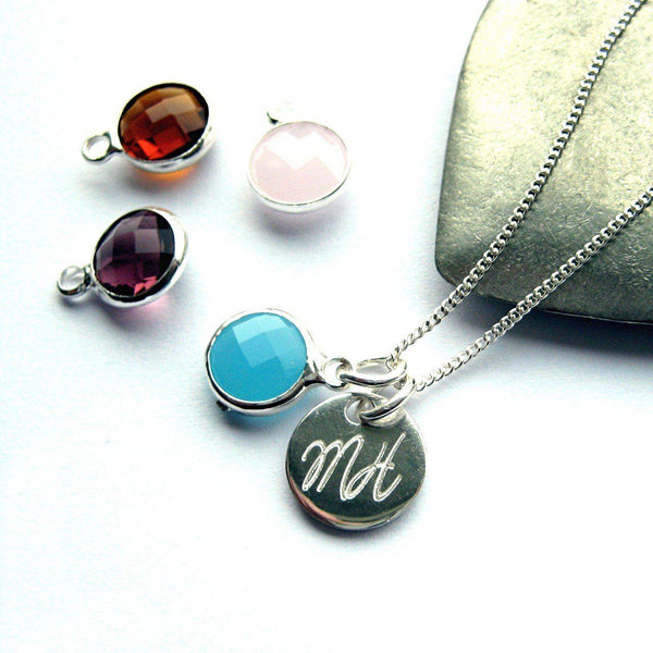 Necklace With Light Blue (Mar) Birthstone And Initials On A SS Disc, Birthstones Dark Red (Jan), Purple (Feb) And Light Pink (Oct) Sit By The Necklace