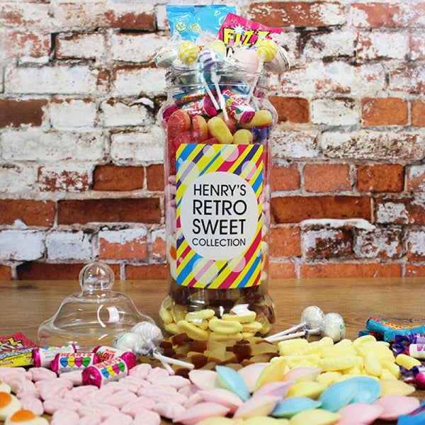 GIANT VICTORIAN RETRO SWEET JAR - SWEETS SPREAD OUT ON A TABLE IN FRONT OF THE SWEET JAR